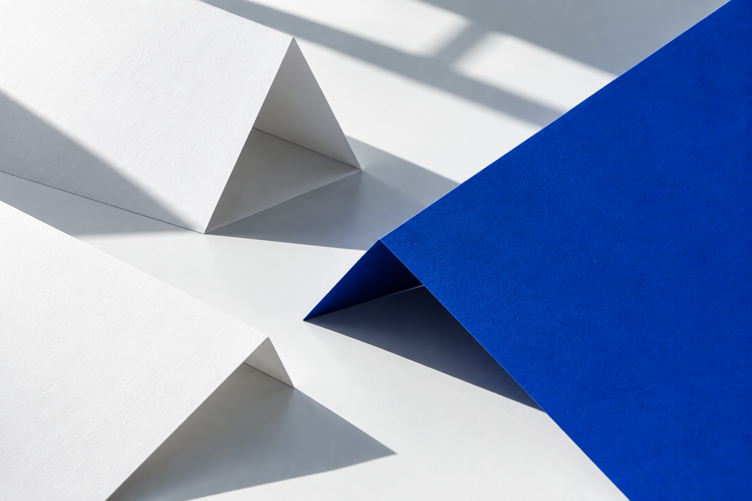 Folded white and cobalt paper in a geometric arrangement